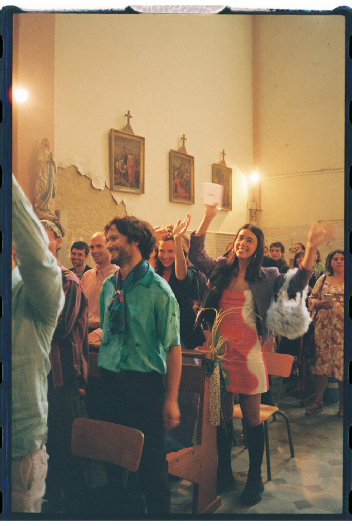 Wedding guests cheering for the couple